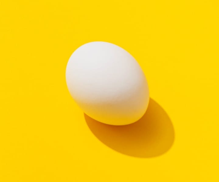 yellow background with an image of an egg